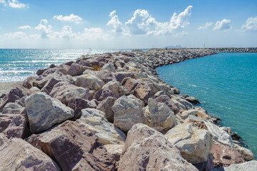 Stone embankment in the harbor of the sea