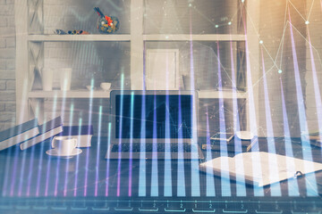 Forex market graph hologram and personal computer on background. Multi exposure. Concept of investment.