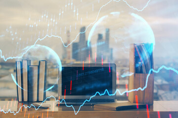 Stock market graph and table with computer background. Multi exposure. Concept of financial...