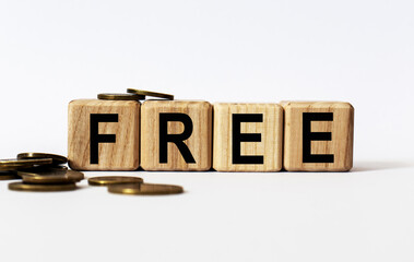 wooden cubes and FREE, coins, the concept of taxation, increase taxes and fees