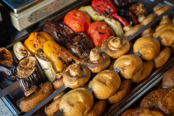 grilled vegetables and mushrooms in an iron tray