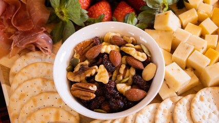 close up of trailmix in a bowl on charcuterie
