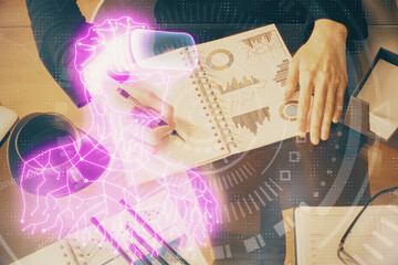 AR hologram over hands taking notes background. Concept of augmented reality. Double exposure