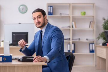 Young male businessman employee working in the office