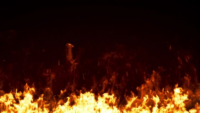 Fire line isolated on black background. Burning hot bonfire sparks rising from the bottom. Close up flame footage. Smoke, embers and particles fly away in air. Realistic fire effect. 4K loop animation