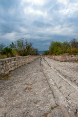 Fototapeta na wymiar The ancient road through ancient ruins