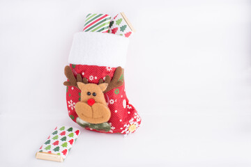 Christmas sock full of chocolates with white background