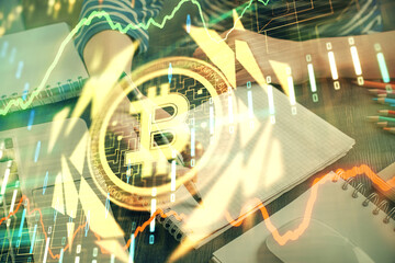 Cryptocurrency hologram, bitcoin, ico theme over hands taking notes background. Concept of...
