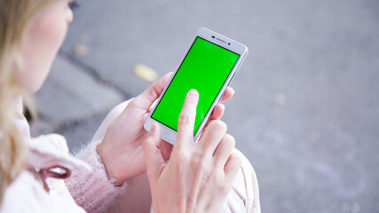 Women holding a phone in the park