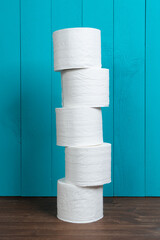 rolls of toilet paper on a wooden table