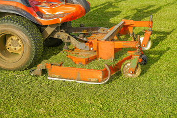 Machine mower on a background of green lawn. Lawn Care. Riding Mower 