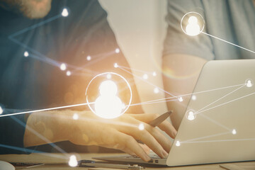Media network theme hologram with man working on computer on background. Concept of internet...