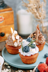 Desserts with cream, blueberries and chocolate. Layout of desserts with nuts on a wooden table.