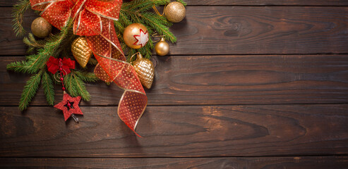 red and golden Christmas decoration with burning candle on wooden background
