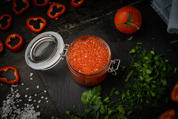Pink salmon caviar in a glass jar. Seafood, delicacies, healthy nutrition. 