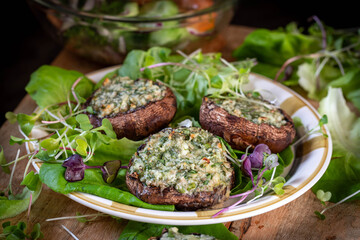 Mushrooms stuffed with cottage cheese, herbson a wooden table. Great Breakfast.