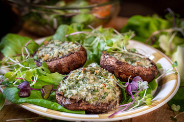 Mushrooms stuffed with cottage cheese, herbson a wooden table. Great Breakfast.