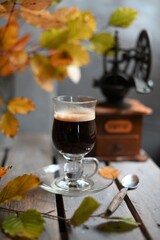 Autumn leaves, Coffee Grinder and cup of black coffee. Background for website, bloggers, social media. 