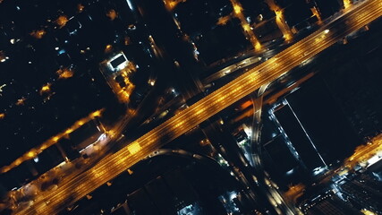 Top down of night lights traffic highway at illuminated streets aerial. Urban Philippine cityscape...
