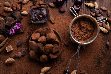 art background with healthy delicious dark truffles, chocolate  and  ingridients:  natural cocoa...