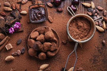 art background with healthy delicious dark truffles, chocolate  and  ingridients:  natural cocoa...