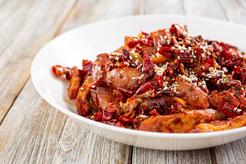 A closeup view of a plate of deep fried pork intestines.