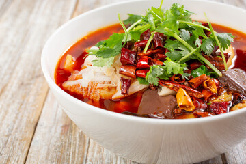 A view of Mao Xue Wang, a Chinese soup made with spicy pork meat parts, blood and veggies.