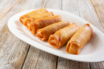 A view of a plate of egg rolls.