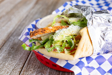 A view of a grilled chicken pita wrap.