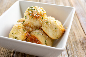 A view of a bowl of garlic knots.