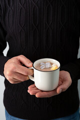 Hot winter beverages in men’s hands, copy space