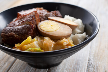 A view of a rice bowl featuring pork belly.