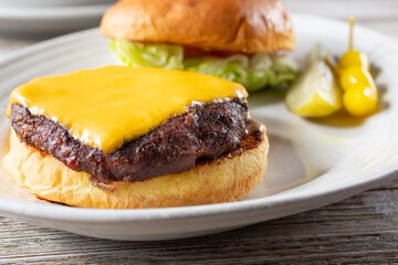 A closeup view of an open face cheeseburger plate.