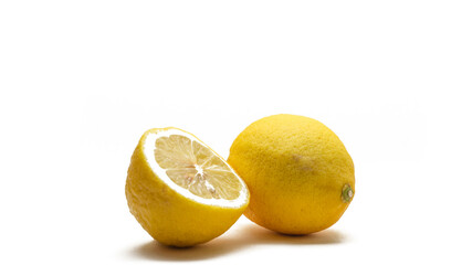 A whole and a half cut fresh yellow lemon on a isolated white background.