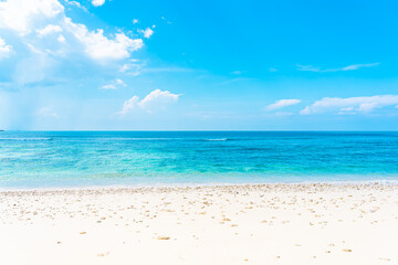 Beautiful tropical empty beach sea ocean with white cloud on blue sky