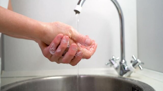 Wash your hands, a woman washes her hands properly under the tap close-up, slow-motion 4K video