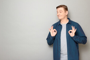 Portrait of happy man showing okay gestures and smiling with pleasure