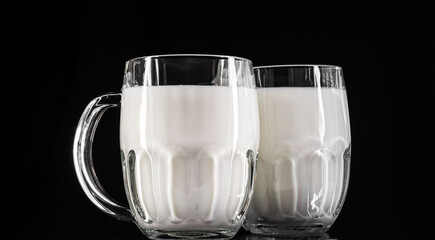 Beer glasses with milk on black background.Anti-alcohol concept.Drink milk-be healthy