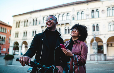 Couple with the bicycle around the city.