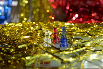 New year's Board game of chess close-up of bright figures made of glass, a gift for the new year