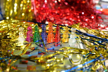 New year's Board game of chess close-up of bright figures made of glass, a gift for the new year