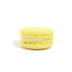 One tasty french yellow macaron isolated on the white background. Colorful macarons. Front view.