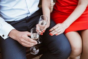 two hands holding glasses of champagne