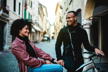 Happy and contented couple sitting on bicycle.