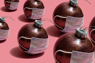 many pink christmas balls in medical masks
