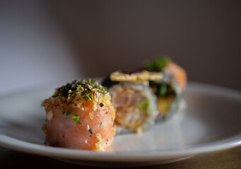 Plate of sushi pieces with salmon, rice and other ingredients	