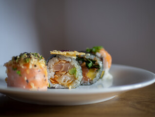 Plate of sushi pieces with salmon, rice and other ingredients