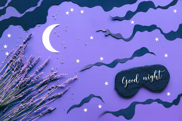 Sleep mask with lavender on purple color background with black clouds, Moon and stars. Text Good night on the mask. Quality of sleep, aromatherapy, scented herbal remedies. Creative flat lay.