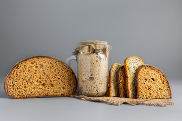 Active rye sourdough for bread and slices of natural whole grain bread