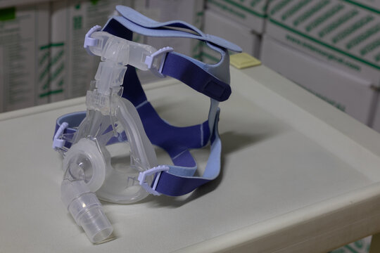 Non-invasive full-face ventilation mask (NIV mask) for non-invasive ventilation therapy is placed on a instrument table. This medical equipment is used for treat respiratory disorders, viral pneumonia